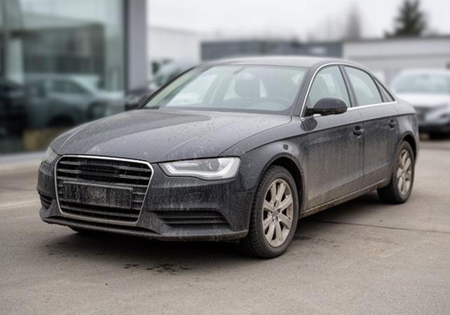 Dealership car before pre-sale detailing with road film visible on dark paintwork